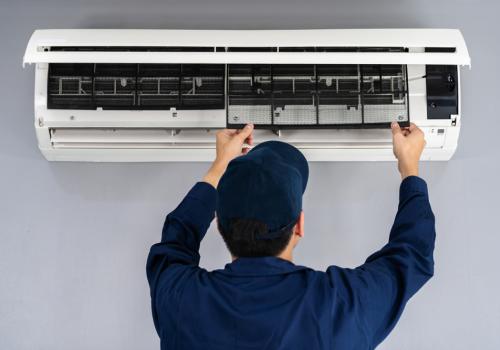electrician inspecting air conditioning unit