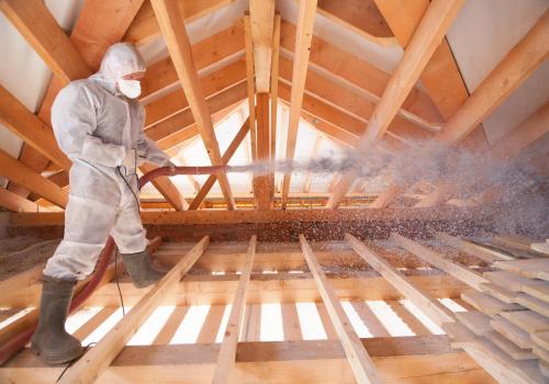 man insulating a home's attic