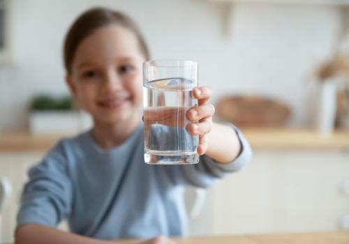 happy girl with a glass of clean water