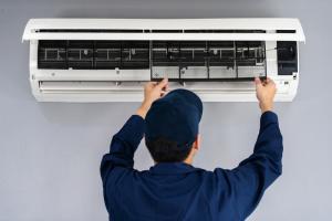 electrician inspecting air conditioning unit