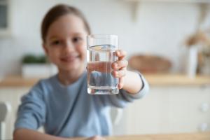 happy girl with a glass of clean water