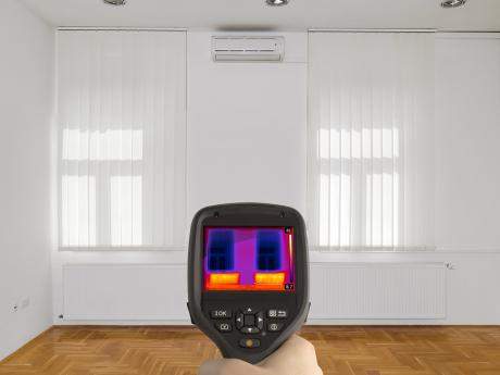 Thermal imaging of bare room with white walls and wooden flooring