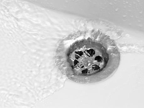 Water flowing down bathroom sink drain