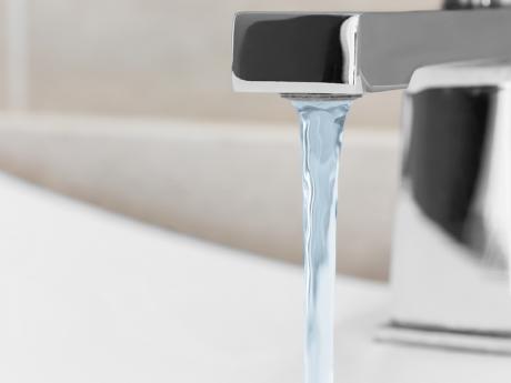 Water coming out of polished silver faucet