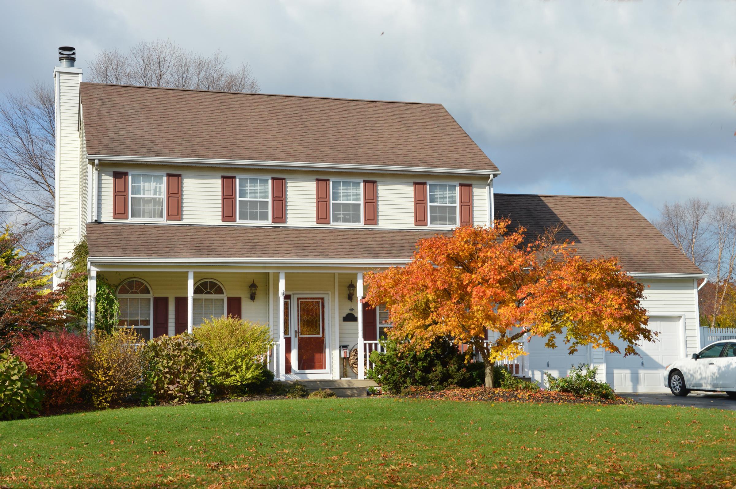 outside of home with autumn colors on the trees