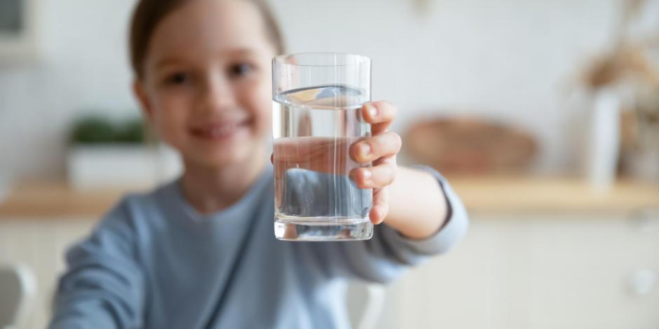 happy girl with a glass of clean water