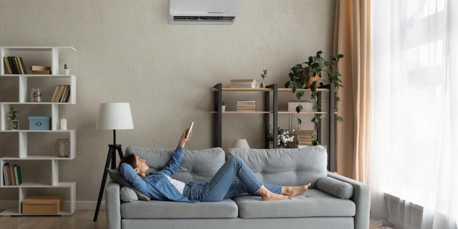 Woman inside on a summer day using her air conditioner