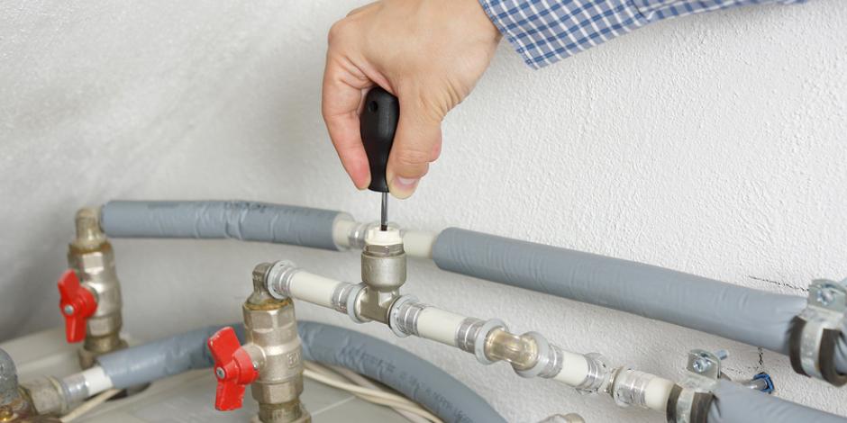 Technician repairing heating system Technician repairing heating system
