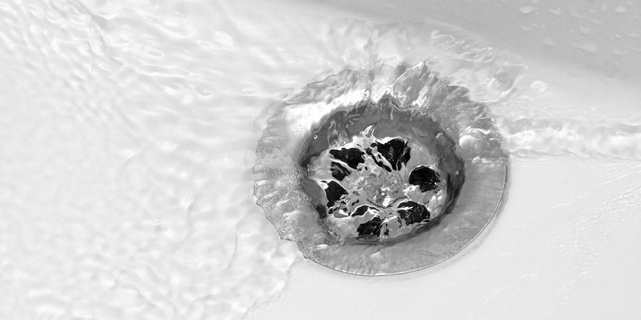 Water flowing down bathroom sink drain